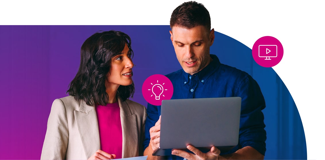 Two colleaugues reveiwing work on a laptop.